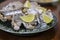 Oysters platter with lemon and ice served on dish