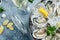 Oysters platter with lemon, lime and ice. Healthy food, gourmet food. Oyster dinner in restaurant