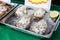 Oysters or seafood on ice at asian street market