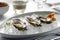 Oysters served on the oval plate in a luxury restaurant, closeup. Generative AI