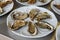 Oysters served on white plate, ready for eat