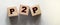 P2P abbreviation written in wooden blocks. Peer to peer business concept