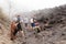 PACAYA, GUATEMALA - MAR 28, 2016: Tourists roasting Marshmallow at the lava field of Pacaya volcano, Guatema