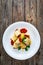 Paccheri con rag alla bolognese - noodles with bolognese sauce on wooden table