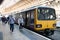 Pacer train on a platform at York Railway Station with passengers departing and walking off the platform