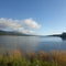 Pacific inlet into Alaska Interior with grasslands, and white clouds and blue skies