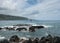 Pacific ocean breaks against lava rocks at Keanae