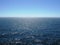 Pacific ocean with clear horizon, bright sunshine, reflections on choppy water