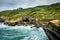 Pacific ocean meets sandy cliffs, Tunnel beach, Dunedin, New Zealand