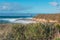 Pacific ocean, rocky cliffs, and silhouette of Morro Rock. View from Montana del Oro state park, CA