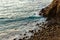 Pacific ocean wave crash on cliffside with rocks