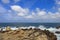 Pacific Ocean waves crashing on the rugged Northern California coastline in Monterey