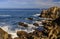 Pacific Ocean waves crashing on the rugged Northern California coastline in Monterey