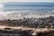 Pacific ocean waves on rocky shore and driftwood