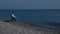 Pacified caucasian woman in a wheelchair on the seashore.