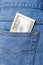 Pack of dollars sticking out of a jeans pocket