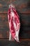 Pack with fresh beef steak cut for sous vide in vacuum plastic market bag, on old dark  wooden table background, top view flat lay