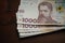 Pack of new Ukrainian 1000 hryvnia bill. Bundle of paper money on a wooden background. Cash money concept. Close up shot