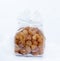 Package of dried longan fruit on background