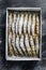 Package of frozen tiger prawns, shrimps. Black background. Top view