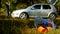 A package of garbage with plastic bottles is lying on the nature, in the background there is a car and people are