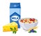 Package with milk, triangle of cheese, bowl with oatmeal, strawberries, bluberries, cereals, parsley