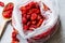 Package of Red Raisins in Plastic Bag with Wooden Spoon.