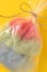 Packaged sweet cotton candy on yellow background, top view