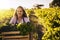 Packed full of green goodness. a young woman holding a crate full of freshly picked produce on a farm.