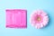 Packed menstrual pads and flower on color background. Gynecological care