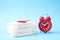 Packed menstrual pads with red feather and alarm clock. Gynecological care