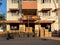 Packers and movers transporting cardboard boxes piled outside a residential building