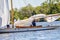 Packing away the sail after a boat race on Wroxham Broad, Norfolk