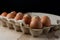 Packing chicken eggs on a wooden background