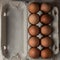 Packing chicken eggs on a wooden background close up