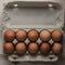 Packing chicken eggs on a wooden background close up