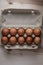 Packing chicken eggs on a wooden background with copy space