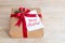 Packing Christmas gifts. Giftbox with ribbon and gift card with text - Merry Christmas. Top view.