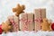 Packing Christmas gifts. Three Christmas gift boxes wrapped in kraft paper tied with red and white string,gingerbread men