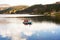 pacucha lake with and boat with tourists sailing on a summer day in andahuaylas peru