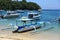 Padang Bai beach with traditional outrigger boats in Bali, Indonesia.