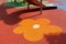 padded rubber sport and safety floor. playing area with red and orange flower pattern