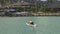 A paddle board surfer going towards the shoreline