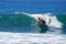 Paddle boarder surfing at St. Anns Beach in Laguna Beach, California.