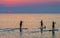 Paddle boarders at sunrise