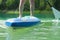Paddle boarding closeup on pure aquamarine water. surfer feet closeup