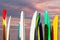 Paddle boards racked against a seascape sunset sky with ocean background