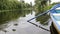 Paddle and boat fragments on lake with lilies and sedge. Little wooden blue boat with paddle on lake at green city park. Part of b