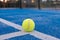 paddle tennis ball on a blue court line , paddle tennis concept