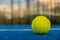 paddle tennis ball on blue paddle tennis court at dusk